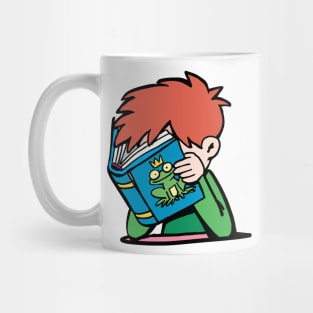 boy with his head in a book reads a fairy tale about a frog prince Mug